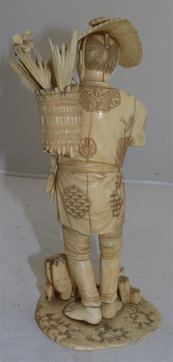 A Japanese sectional ivory figure of a flower seller, early 20th century, 26.5cm A/F